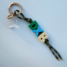 Load image into Gallery viewer, ‘DXB’ CORD BAG CHARM / KEYRING BY BOOMBESPOKE
